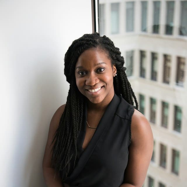 Temporary sample portrait of a smiling woman in a dark sleeveless top; stock model, not a Dillon’s employee.